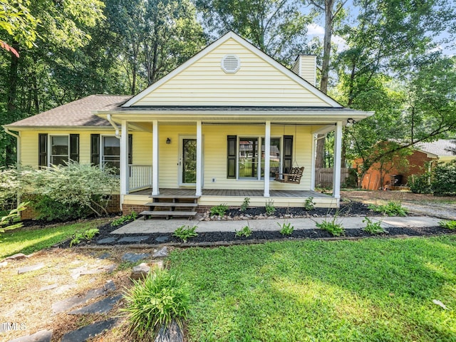 129 Nottingham Ct, Youngsville, NC 27596 - view of front facade with a chimney, a porch, and a front yard