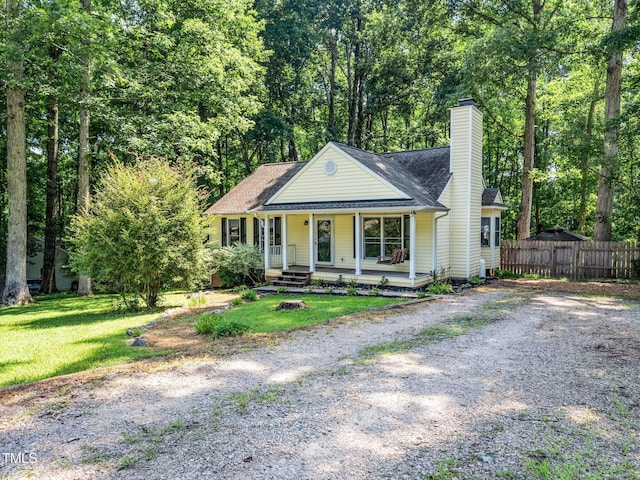 129 Nottingham Ct, Youngsville, NC 27596 - view of front of home featuring a chimney, covered porch, and roof with shingles