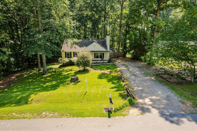 129 Nottingham Ct, Youngsville, NC 27596 - view of front of home with a chimney, gravel driveway, and covered porch