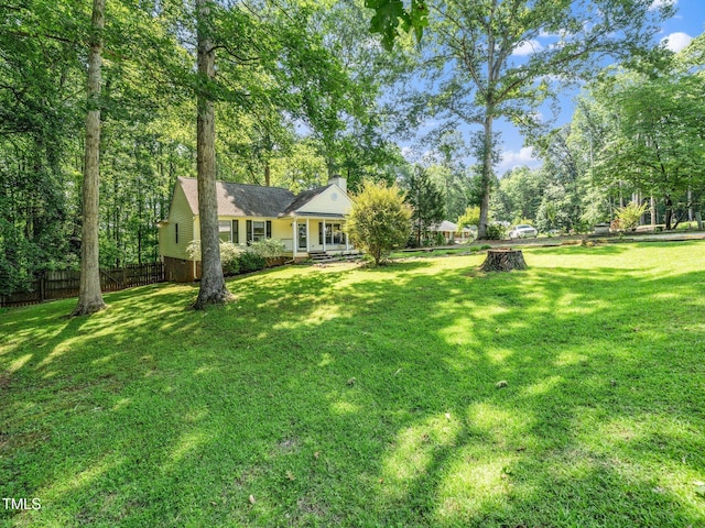 129 Nottingham Ct, Youngsville, NC 27596 - view of yard with covered porch and view of scattered trees