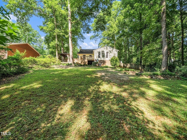 129 Nottingham Ct, Youngsville, NC 27596 - view of grassy yard with a wooden deck
