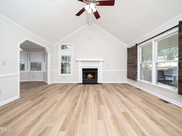 129 Nottingham Ct, Youngsville, NC 27596 - unfurnished living room with a fireplace with flush hearth, a ceiling fan, crown molding, light wood-style floors, and lofted ceiling