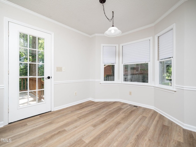 129 Nottingham Ct, Youngsville, NC 27596 - unfurnished dining area featuring light wood-style flooring, ornamental molding, and a textured ceiling