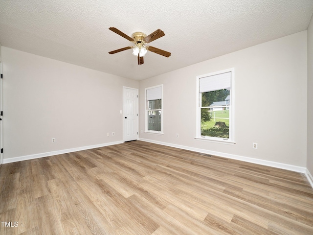 129 Nottingham Ct, Youngsville, NC 27596 - spare room featuring light wood-style flooring, ceiling fan, and a textured ceiling