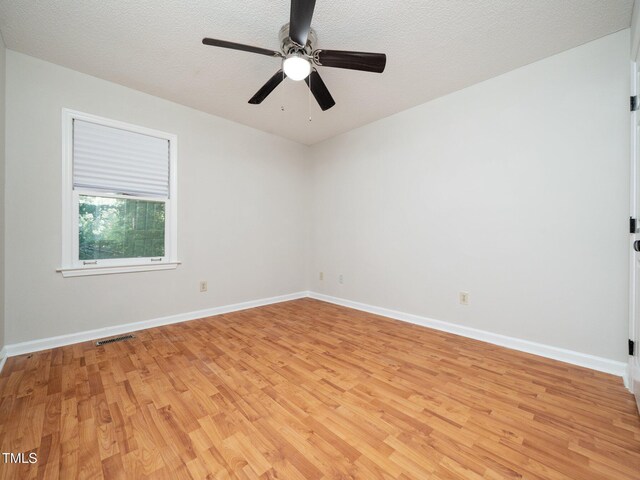 129 Nottingham Ct, Youngsville, NC 27596 - unfurnished room with light wood-type flooring, a ceiling fan, and a textured ceiling