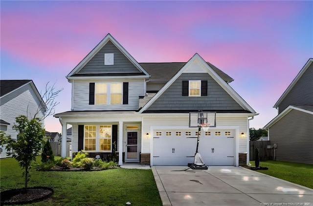 1657 Stackhouse Dr, Fayetteville, NC 28314 - traditional home with driveway, a lawn, a garage, and covered porch