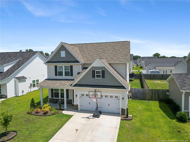 1657 Stackhouse Dr, Fayetteville, NC 28314 - view of front of home with a porch, driveway, a shingled roof, stone siding, and a garage