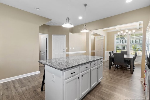 1657 Stackhouse Dr, Fayetteville, NC 28314 - kitchen with a center island, recessed lighting, wood finished floors, a chandelier, and a breakfast bar area