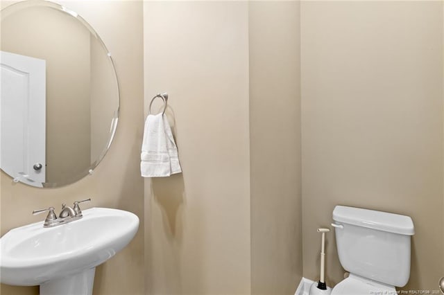 1657 Stackhouse Dr, Fayetteville, NC 28314 - half bath featuring a sink and toilet