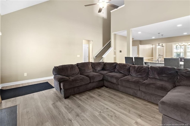 1657 Stackhouse Dr, Fayetteville, NC 28314 - living area featuring ceiling fan, light wood-style flooring, high vaulted ceiling, recessed lighting, and a chandelier