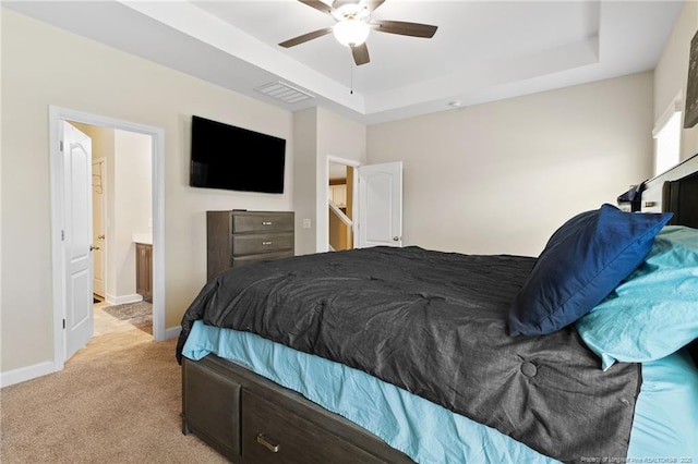 1657 Stackhouse Dr, Fayetteville, NC 28314 - bedroom featuring light carpet, a tray ceiling, ceiling fan, and ensuite bath