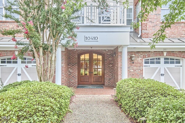10410 Rosegate Ct Unit 105, Raleigh, NC 27617 - view of exterior entry featuring french doors, brick siding, and a garage