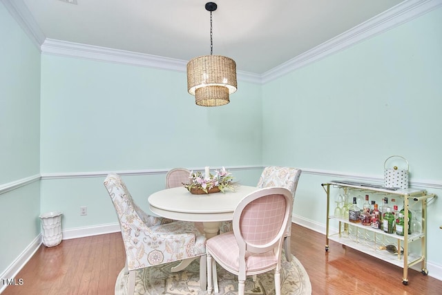 10410 Rosegate Ct Unit 105, Raleigh, NC 27617 - dining room with ornamental molding, wood finished floors, and a chandelier