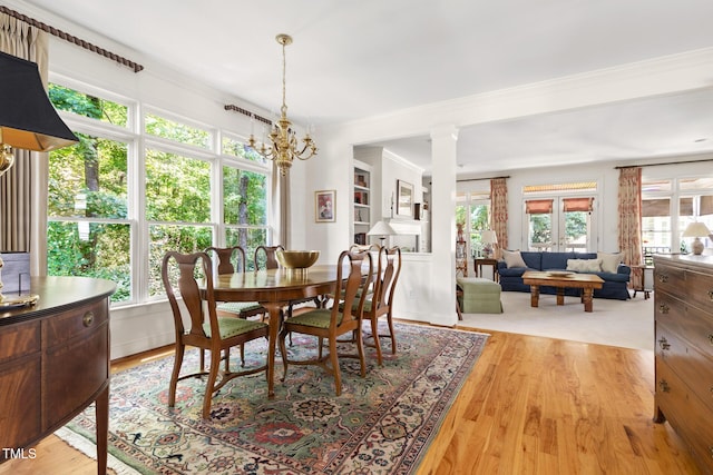 201 Weathervane Dr, Carrboro, NC 27510 - dining area with healthy amount of natural light, light wood finished floors, a chandelier, and ornamental molding
