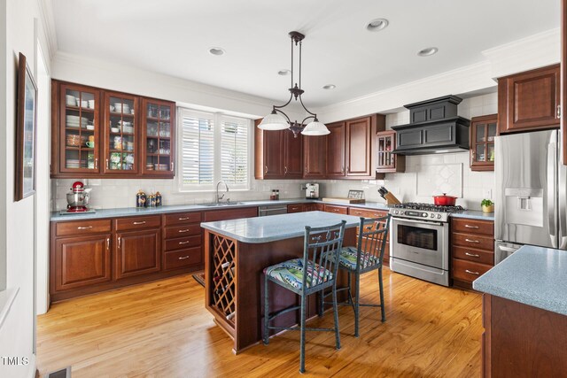 201 Weathervane Dr, Carrboro, NC 27510 - kitchen with appliances with stainless steel finishes, custom range hood, decorative backsplash, a kitchen bar, and crown molding