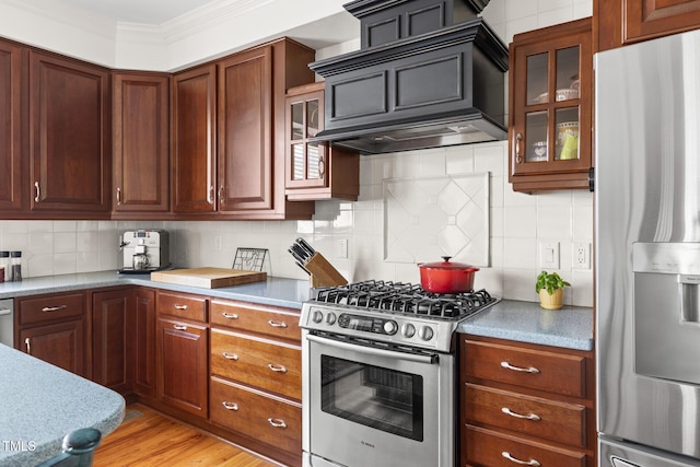 201 Weathervane Dr, Carrboro, NC 27510 - kitchen featuring appliances with stainless steel finishes, wall chimney range hood, glass insert cabinets, crown molding, and backsplash
