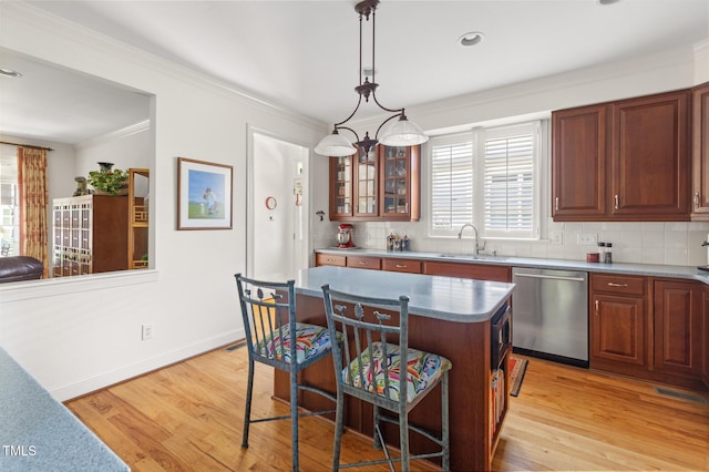 201 Weathervane Dr, Carrboro, NC 27510 - kitchen with dishwasher, a breakfast bar, tasteful backsplash, ornamental molding, and glass insert cabinets