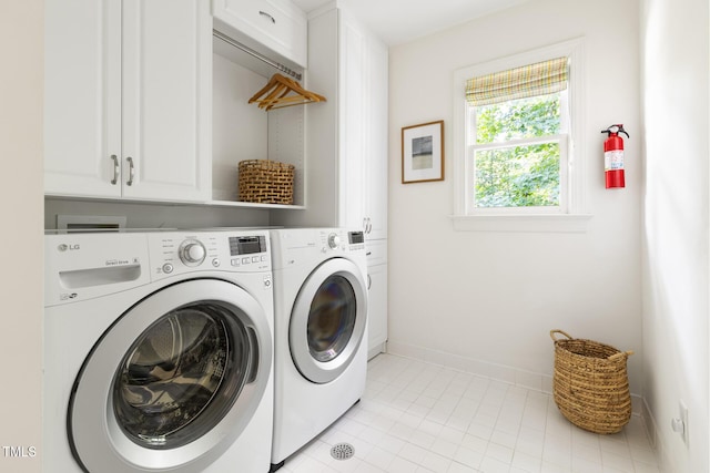 201 Weathervane Dr, Carrboro, NC 27510 - laundry area featuring washer and clothes dryer, cabinet space, and light tile patterned floors