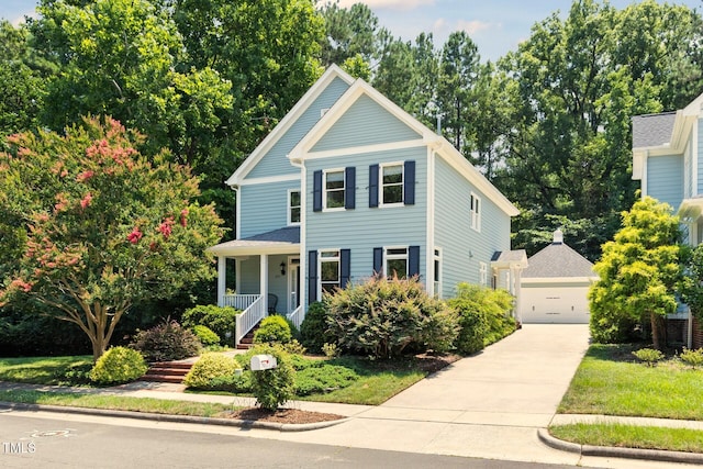 201 Weathervane Dr, Carrboro, NC 27510 - view of front of house with a porch, a garage, and view of scattered trees