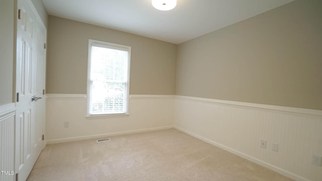 8001 Flanagan Pl, Raleigh, NC 27612 - unfurnished room with wainscoting and carpet flooring