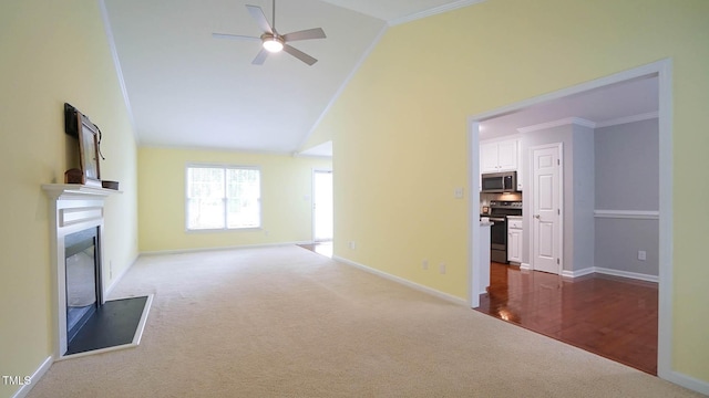 8001 Flanagan Pl, Raleigh, NC 27612 - unfurnished living room featuring dark colored carpet, ceiling fan, crown molding, a fireplace with raised hearth, and vaulted ceiling
