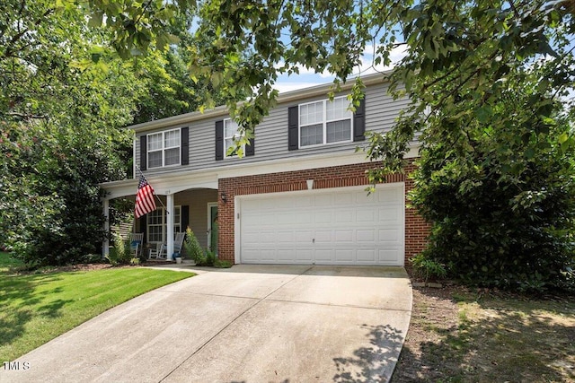 109 Covenant Rock Ln, Holly Springs, NC 27540 - traditional home featuring brick siding, driveway, an attached garage, a front yard, and covered porch