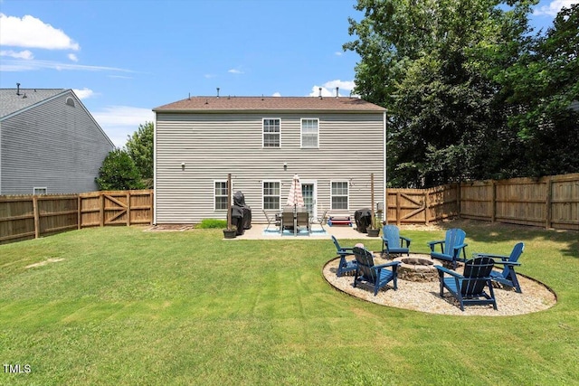 109 Covenant Rock Ln, Holly Springs, NC 27540 - rear view of house with a fire pit, a patio area, a fenced backyard, and a gate