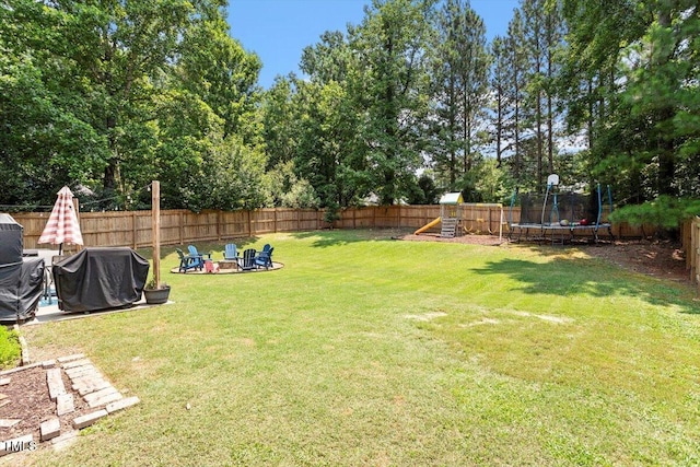 109 Covenant Rock Ln, Holly Springs, NC 27540 - fenced backyard featuring a trampoline, a playground, and a fire pit