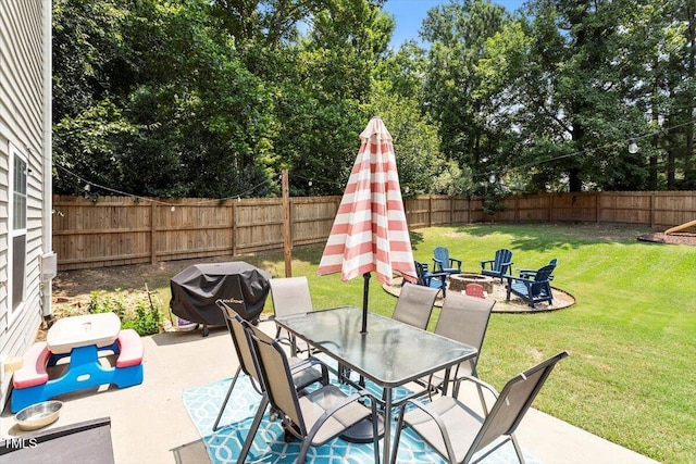 109 Covenant Rock Ln, Holly Springs, NC 27540 - fenced backyard featuring a fire pit, a patio, and outdoor dining space