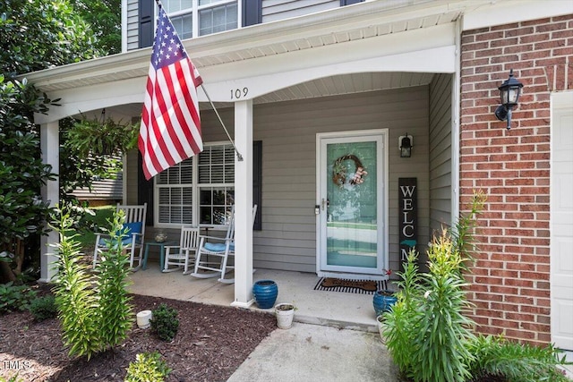 109 Covenant Rock Ln, Holly Springs, NC 27540 - view of exterior entry featuring covered porch and brick siding