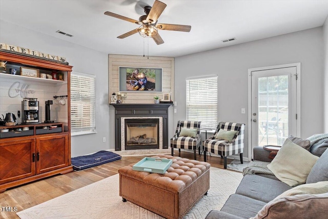 109 Covenant Rock Ln, Holly Springs, NC 27540 - living room with ceiling fan, light wood-type flooring, and a glass covered fireplace
