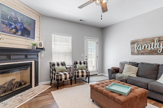 109 Covenant Rock Ln, Holly Springs, NC 27540 - living area featuring wood finished floors, ceiling fan, and a glass covered fireplace
