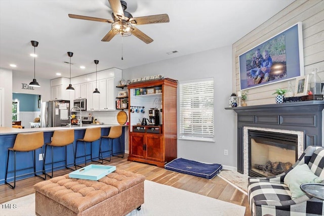 109 Covenant Rock Ln, Holly Springs, NC 27540 - living room with a ceiling fan, recessed lighting, light wood-style flooring, and a large fireplace