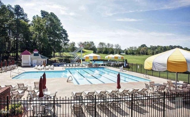 109 Covenant Rock Ln, Holly Springs, NC 27540 - community pool with a patio and view of wooded area