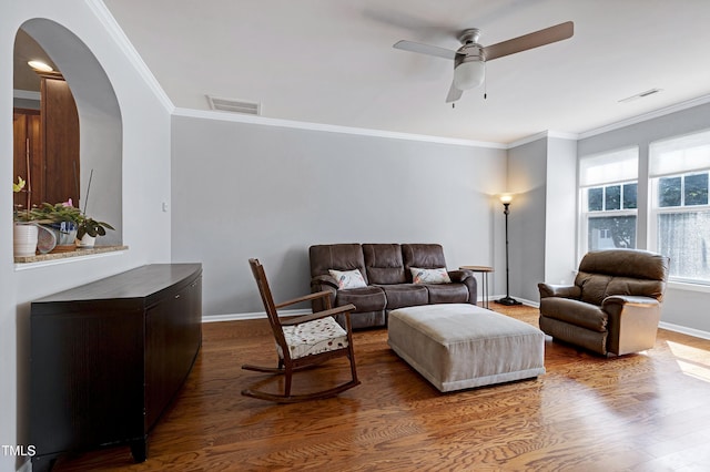 5809 Cameo Glass Way, Raleigh, NC 27612 - living area with arched walkways, a ceiling fan, crown molding, and dark wood-style flooring