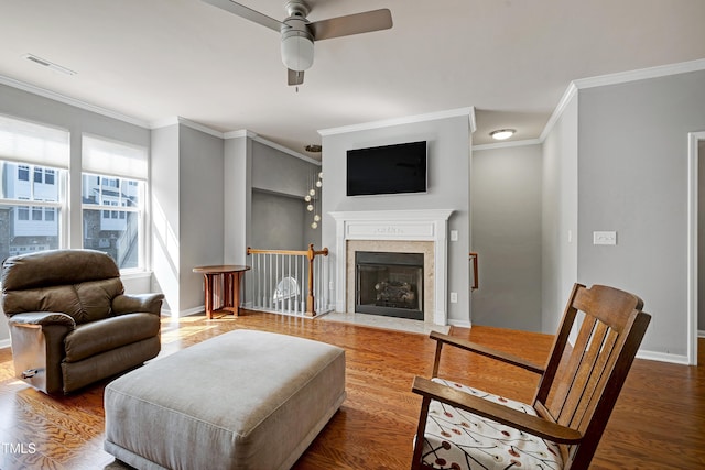 5809 Cameo Glass Way, Raleigh, NC 27612 - living room with ceiling fan, crown molding, wood finished floors, and a fireplace with flush hearth
