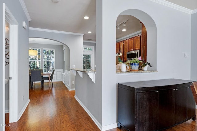 5809 Cameo Glass Way, Raleigh, NC 27612 - corridor featuring dark wood-type flooring, arched walkways, ornamental molding, and recessed lighting