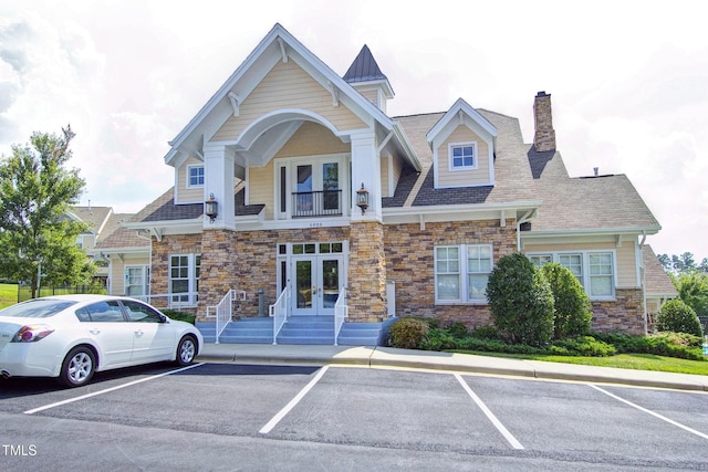 5809 Cameo Glass Way, Raleigh, NC 27612 - craftsman house with french doors, stone siding, uncovered parking, a chimney, and a balcony