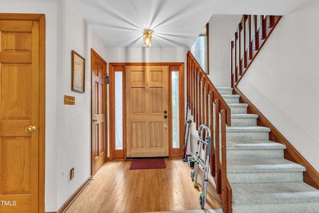 128 Chris Ct, Garner, NC 27529 - foyer entrance featuring light wood-style floors and stairs