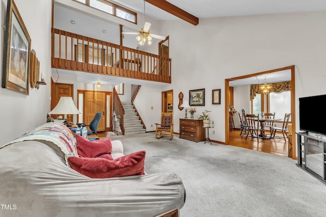 128 Chris Ct, Garner, NC 27529 - carpeted living area with high vaulted ceiling, stairway, beamed ceiling, ceiling fan, and a chandelier