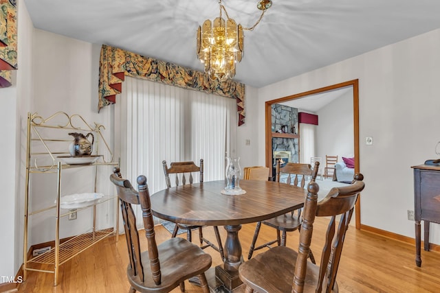 128 Chris Ct, Garner, NC 27529 - dining room featuring a chandelier and light wood finished floors