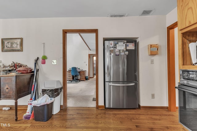 128 Chris Ct, Garner, NC 27529 - kitchen featuring freestanding refrigerator, oven, wood finished floors, and a desk
