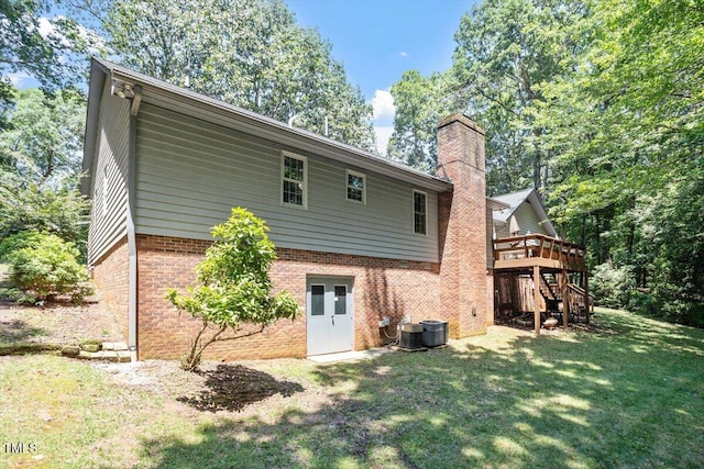 8704 Mill House Ln, Bahama, NC 27503 - rear view of property with a yard, a deck, stairs, a chimney, and brick siding