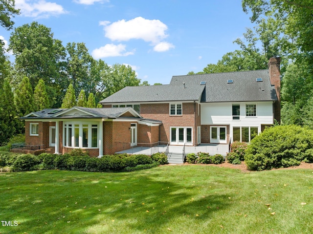 1820 Hunting Ridge Rd, Raleigh, NC 27615 - back of house featuring brick siding, a chimney, and a yard