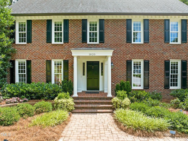 1820 Hunting Ridge Rd, Raleigh, NC 27615 - view of front facade with brick siding and roof with shingles
