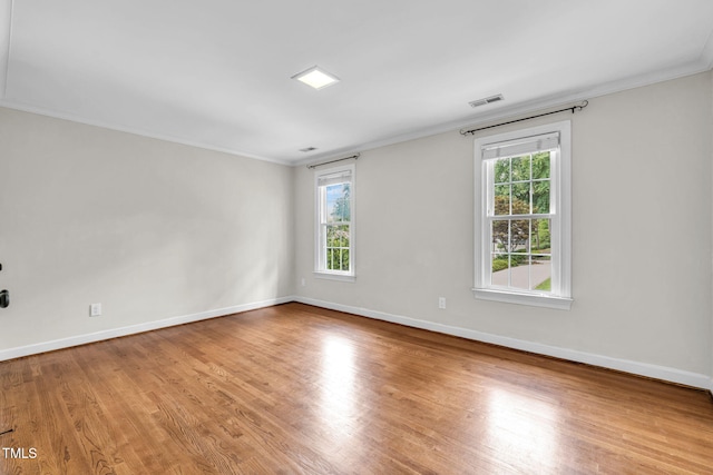 1820 Hunting Ridge Rd, Raleigh, NC 27615 - empty room with crown molding, healthy amount of natural light, and wood finished floors