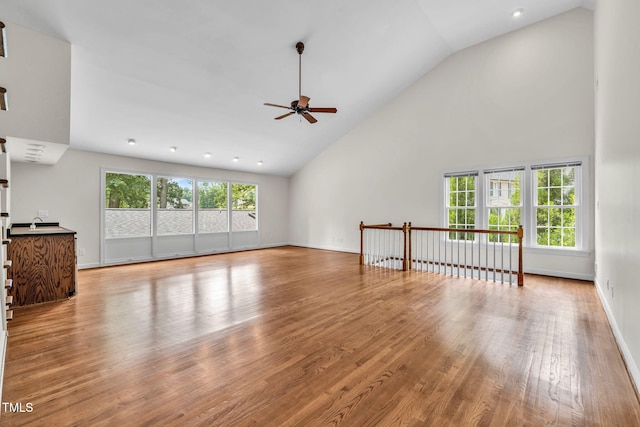 1820 Hunting Ridge Rd, Raleigh, NC 27615 - unfurnished living room featuring a ceiling fan, high vaulted ceiling, wood finished floors, and recessed lighting