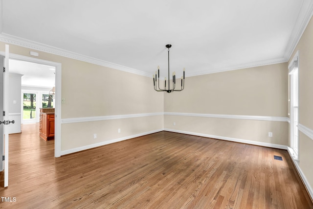 1820 Hunting Ridge Rd, Raleigh, NC 27615 - unfurnished room featuring a chandelier, wood finished floors, and crown molding