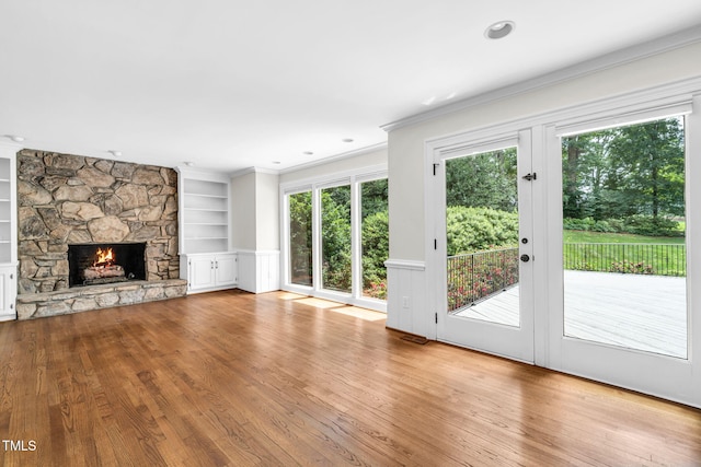1820 Hunting Ridge Rd, Raleigh, NC 27615 - unfurnished living room with built in features, crown molding, wood finished floors, and a fireplace