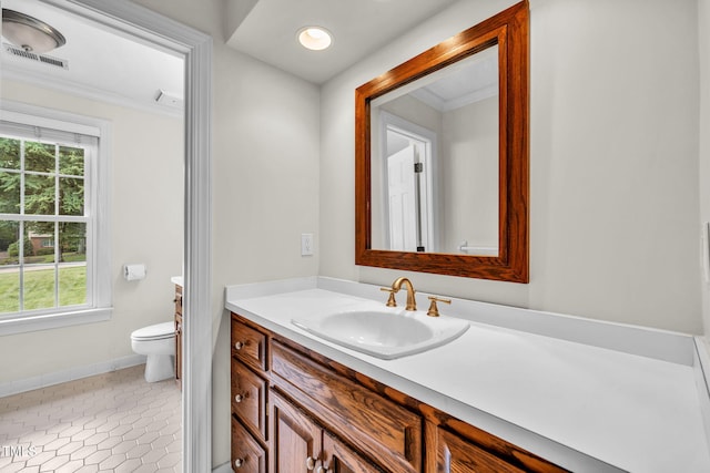 1820 Hunting Ridge Rd, Raleigh, NC 27615 - bathroom featuring vanity, healthy amount of natural light, ornamental molding, and tile patterned floors